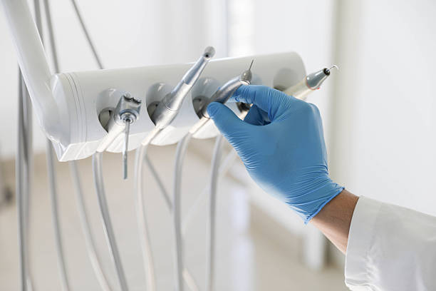 Professional Tooth Extraction technician working in Gang Mills, NY